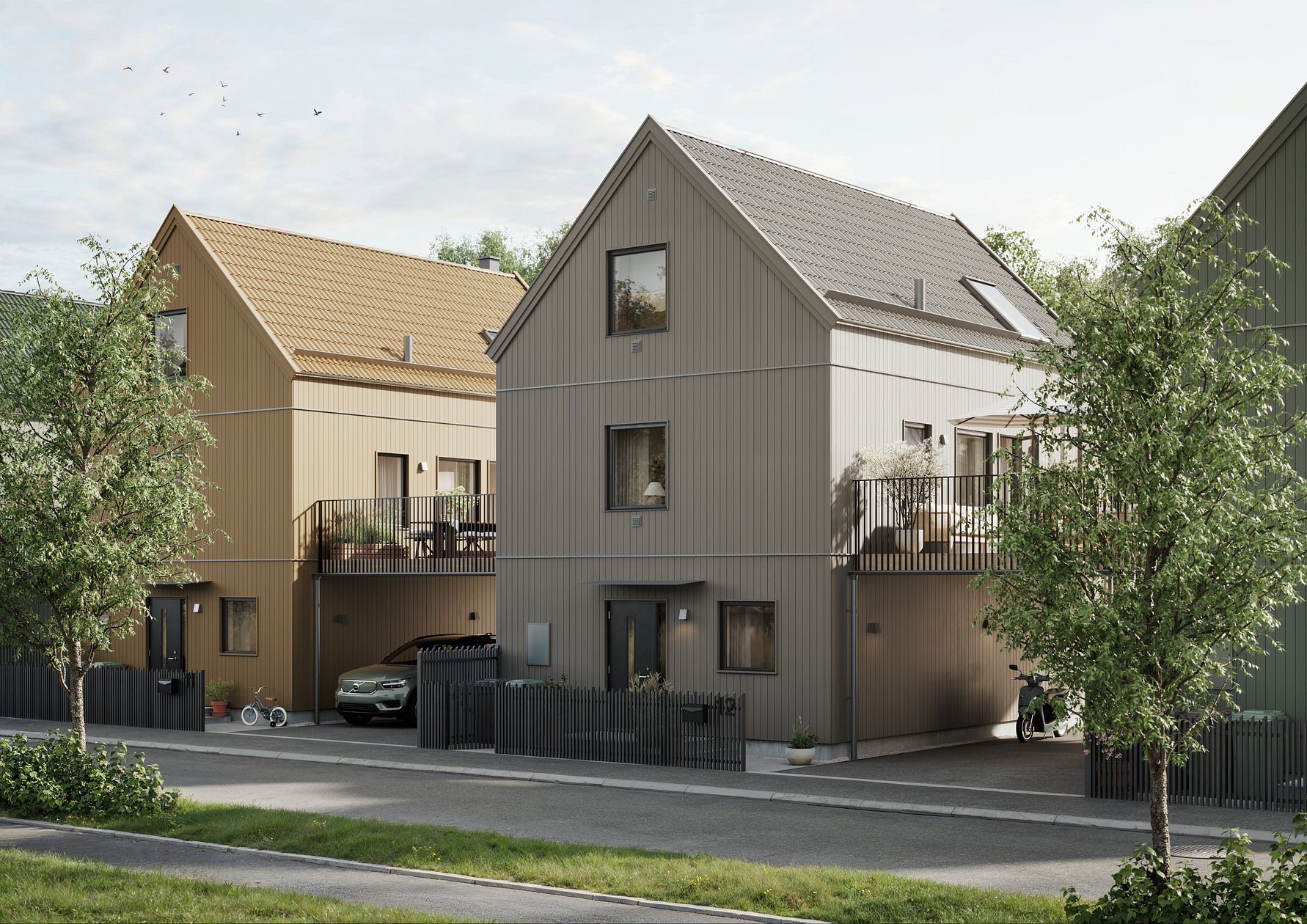 Två moderna tvåvåningshus med träfasader, omgivna av träd och grönska, belägna vid en lugn väg