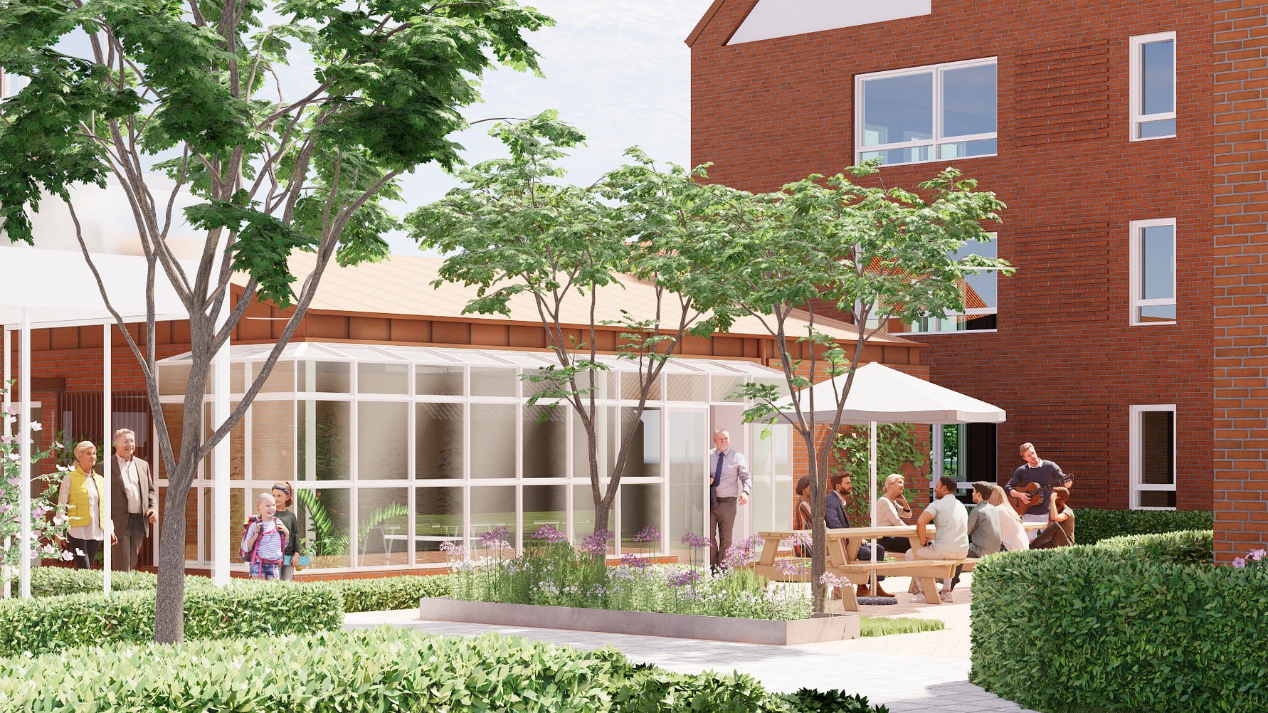 Utemiljö med trädgård, sittgrupper, träd och buskar framför byggnader med röda tegelväggar och stora fönster