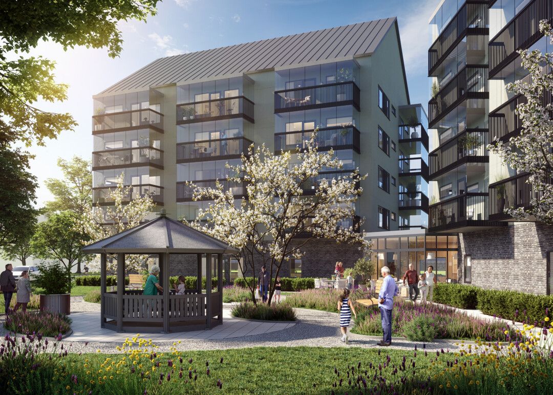 Modernt bostadsområde med lägenhetsbyggnader, grönskande omgivning, blommor, och ett lusthus i en trädgård där människor promenerar och samtalar