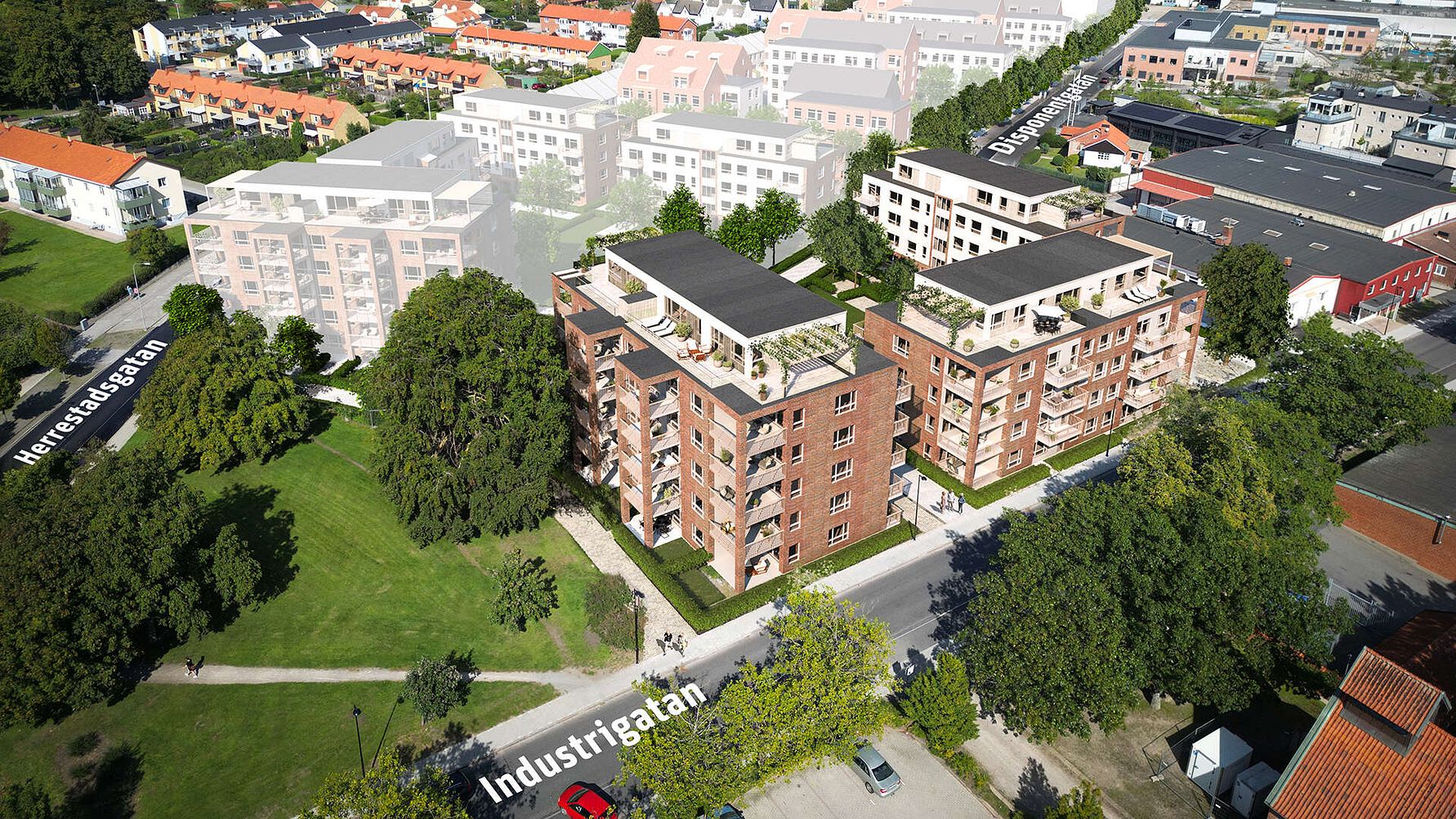 Flygvy över ett bostadsområde med moderna flerfamiljshus, omgivande grönområden och närliggande vägar såsom Industrigatan