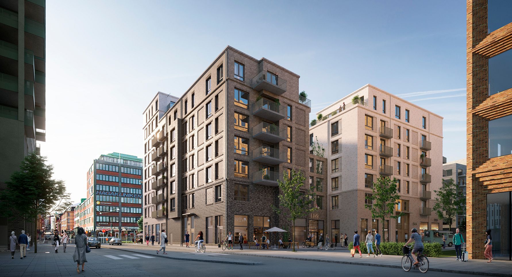 Flera moderna flerfamiljshus med tegel- och putsfasader på en urban gata med fotgängare och cyklister i dagsljus