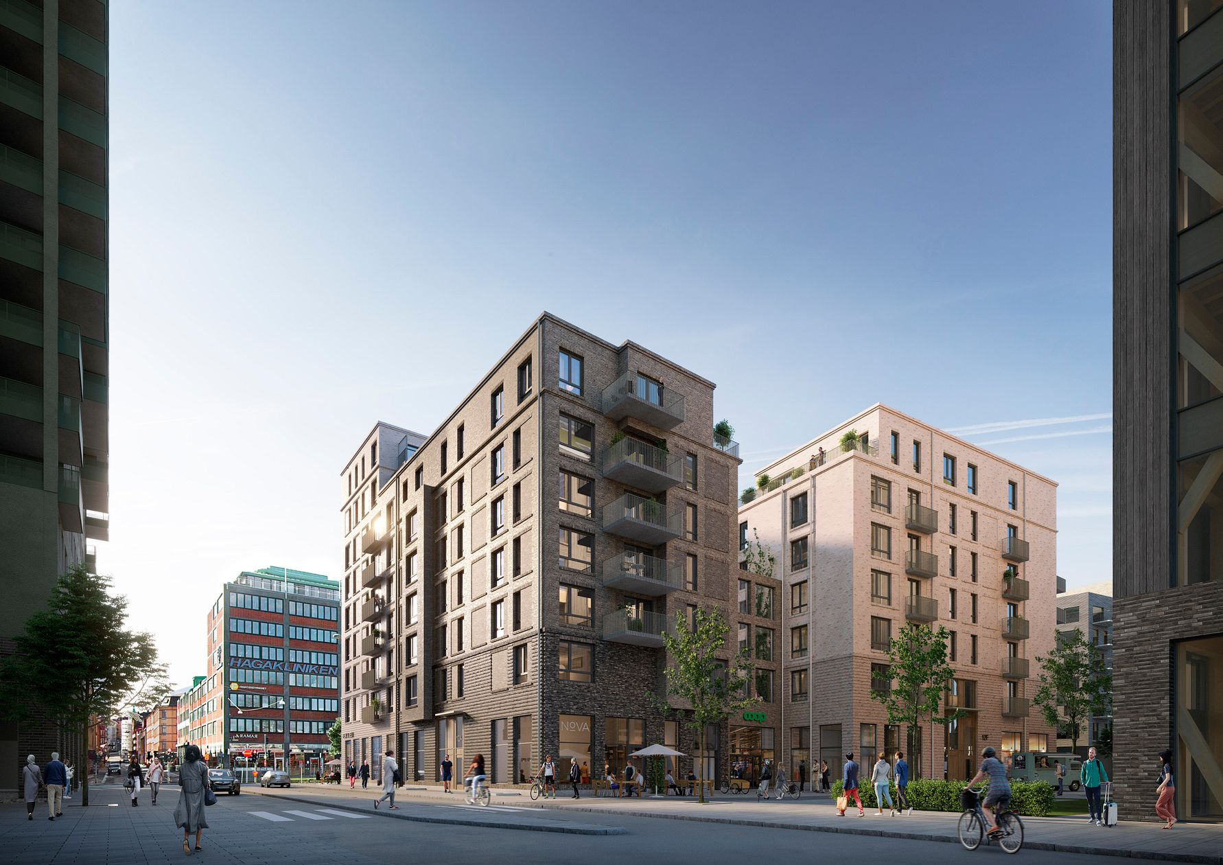 Flera moderna flerfamiljshus i stadsområde med människor som promenerar och cyklar, omgivna av träd och stadsliv