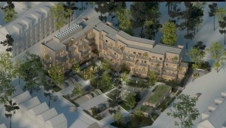 Luftvy av ett bostadskomplex med gröna trädgårdsområden och omgivande byggnader