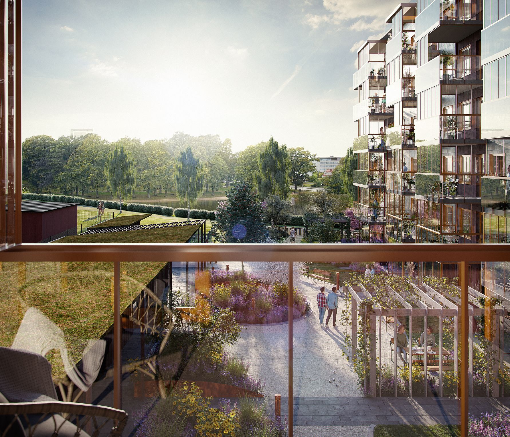 Modern lägenhetskomplex med stora fönster, grönområden och trädgårdar, sett från en balkong med utsikt över en gångväg och landskap