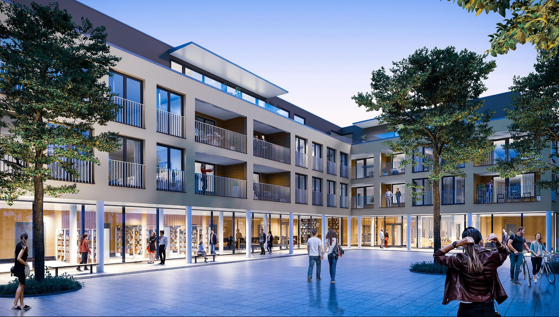 Modern byggnadskomplex med glasfasader, balkonger och butiker på markplan, omgiven av träd och människor på ett stenlagt torg