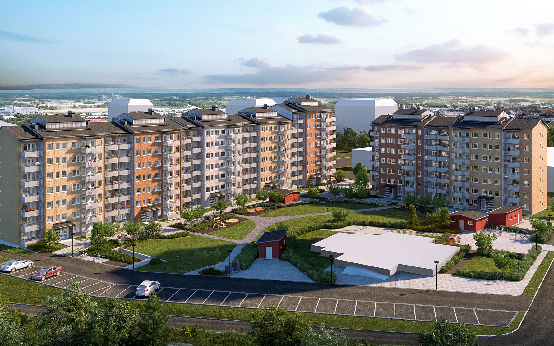 Nybyggda flerfamiljshus med balkonger, omgivna av grönområden och parkeringsplatser, under en molnig himmel