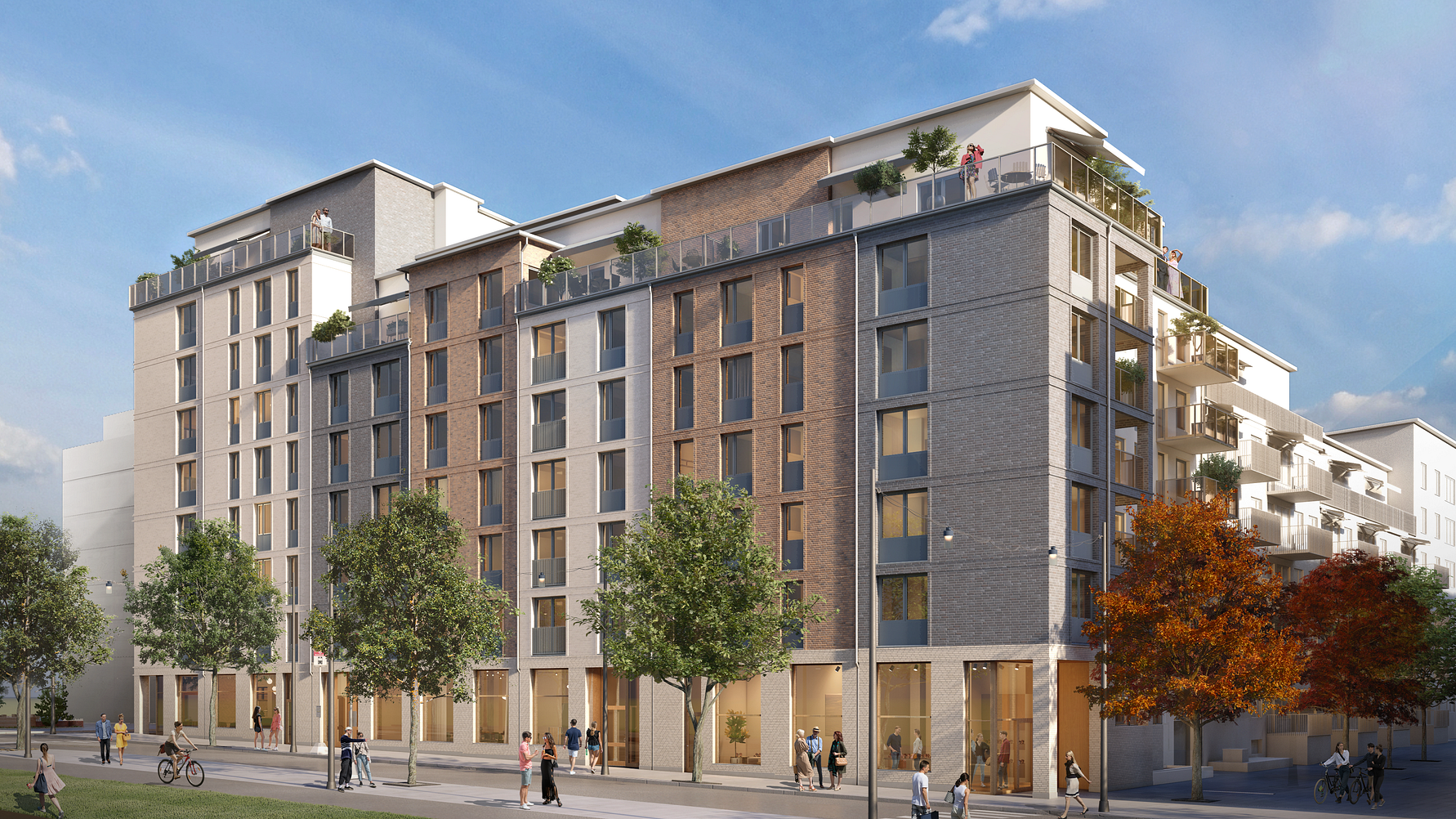 Nybyggnad med moderna flerfamiljshus, grönskande träd och människor som promenerar i ett stadsområde under en klarblå himmel