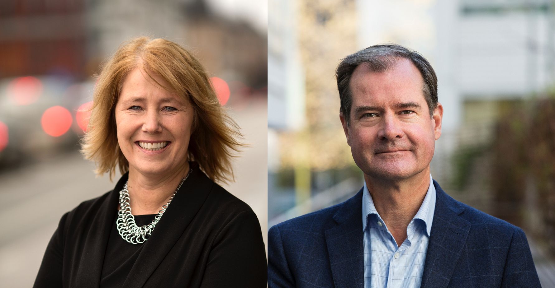 Två personer i formell klädsel, en kvinna med blont hår och ett halsband samt en man i blå kavaj och ljusblå skjorta, utomhus med oskarp stadsmiljö i bakgrunden