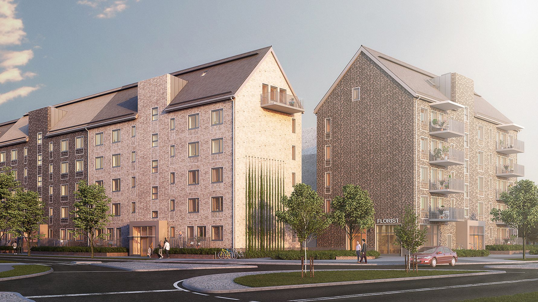 Två flerbostadshus i tegel, omgivna av grönska, med en bil och gångvägar i förgrunden