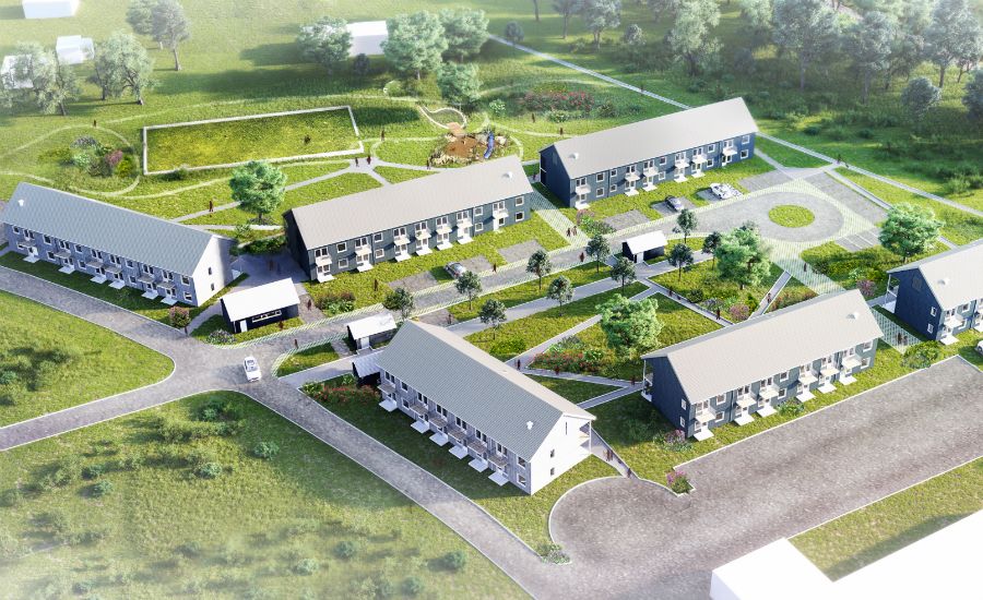 Fågelperspektiv av ett bostadsområde med flera byggnader, grönområden, gångvägar och träd