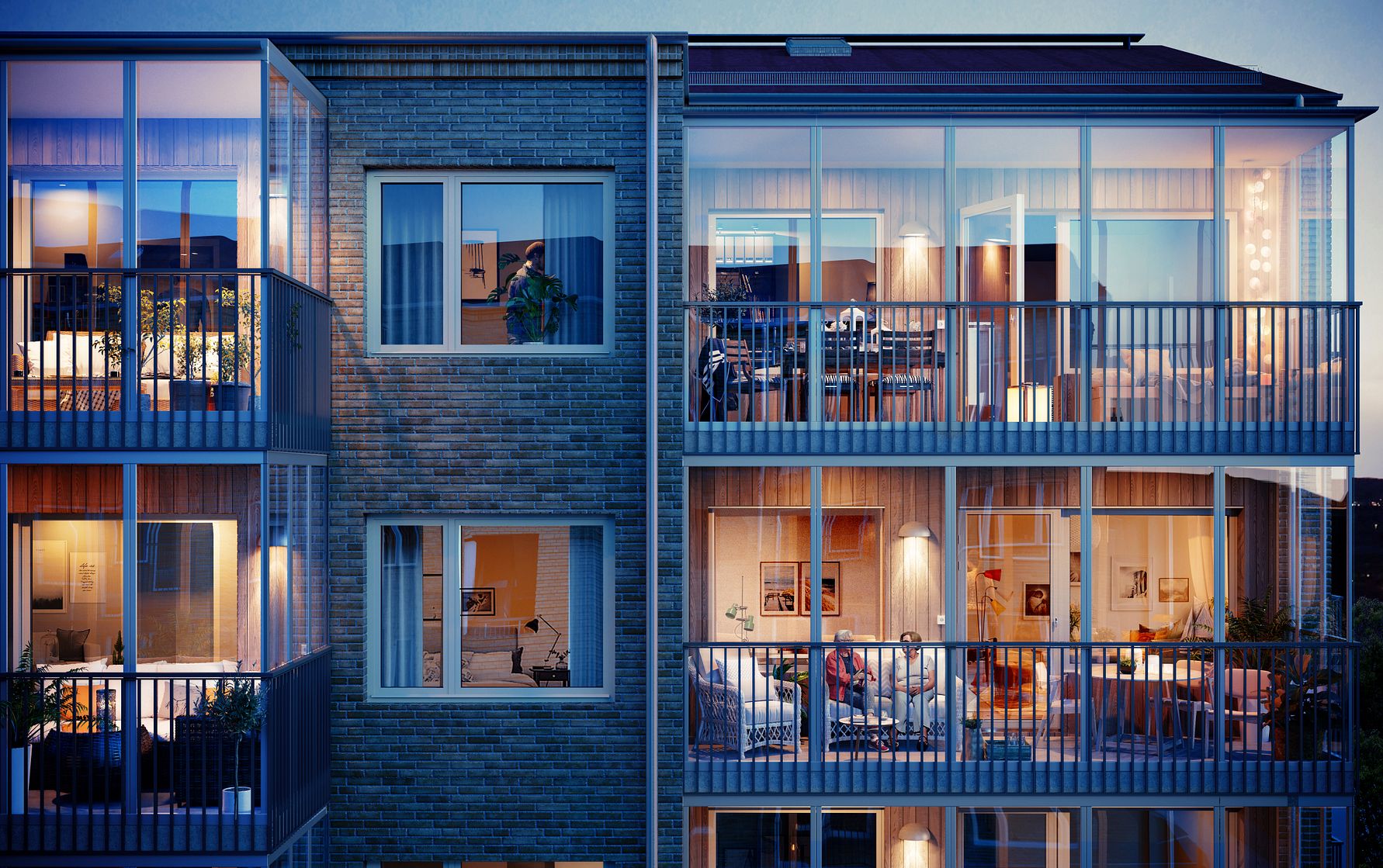 Flerfamiljshus i kvällsljus med upplysta lägenheter och balkonger