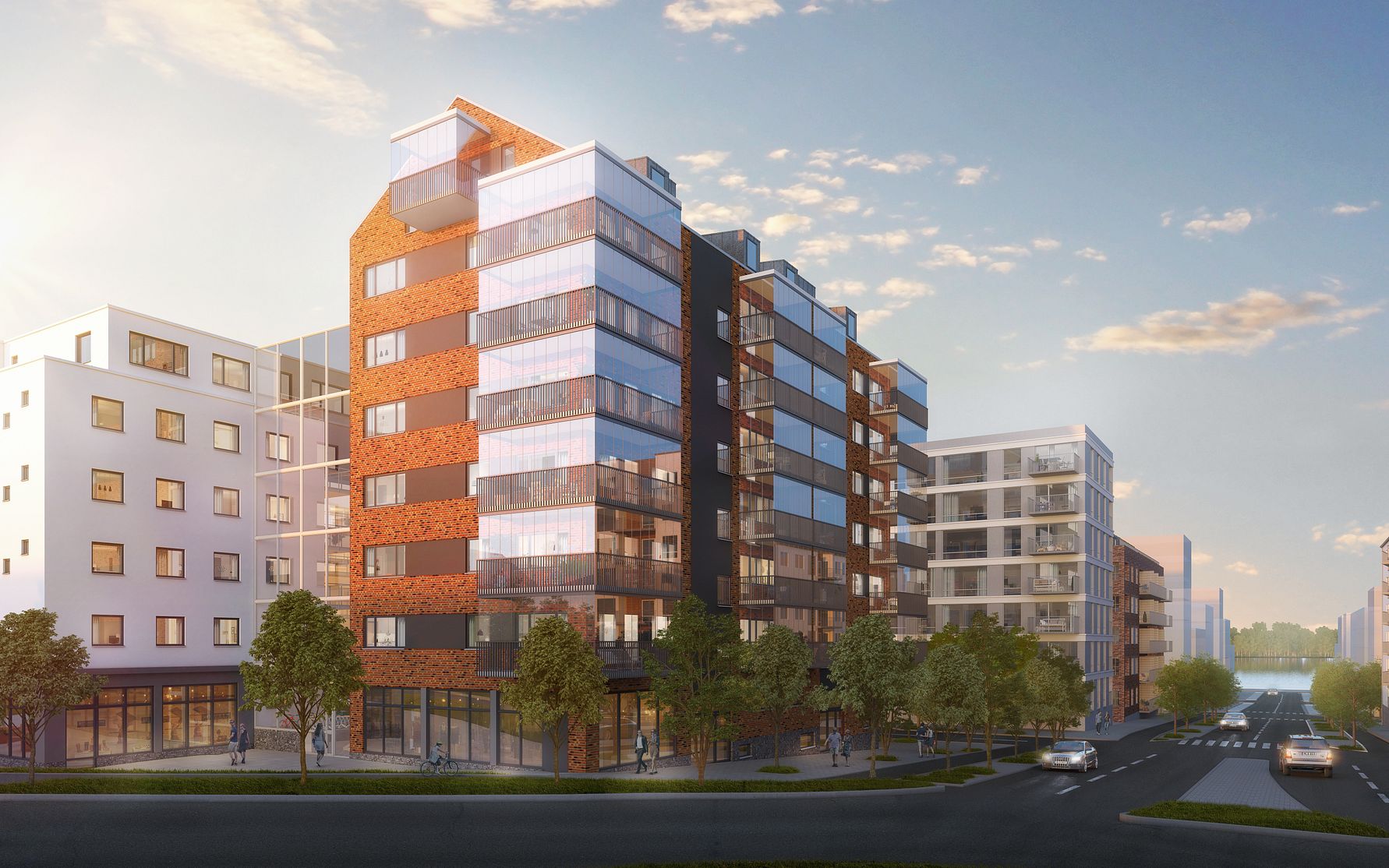 Flerbostadshus med moderna fasader i olika material, omgivna av träd och en väg i stadsmiljö