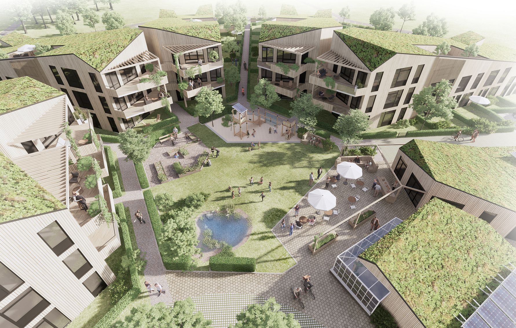 Flygvy över ett modernt bostadsområde med gröna tak, lägenhetsbyggnader, grönområden, en liten damm och människor i olika aktiviteter