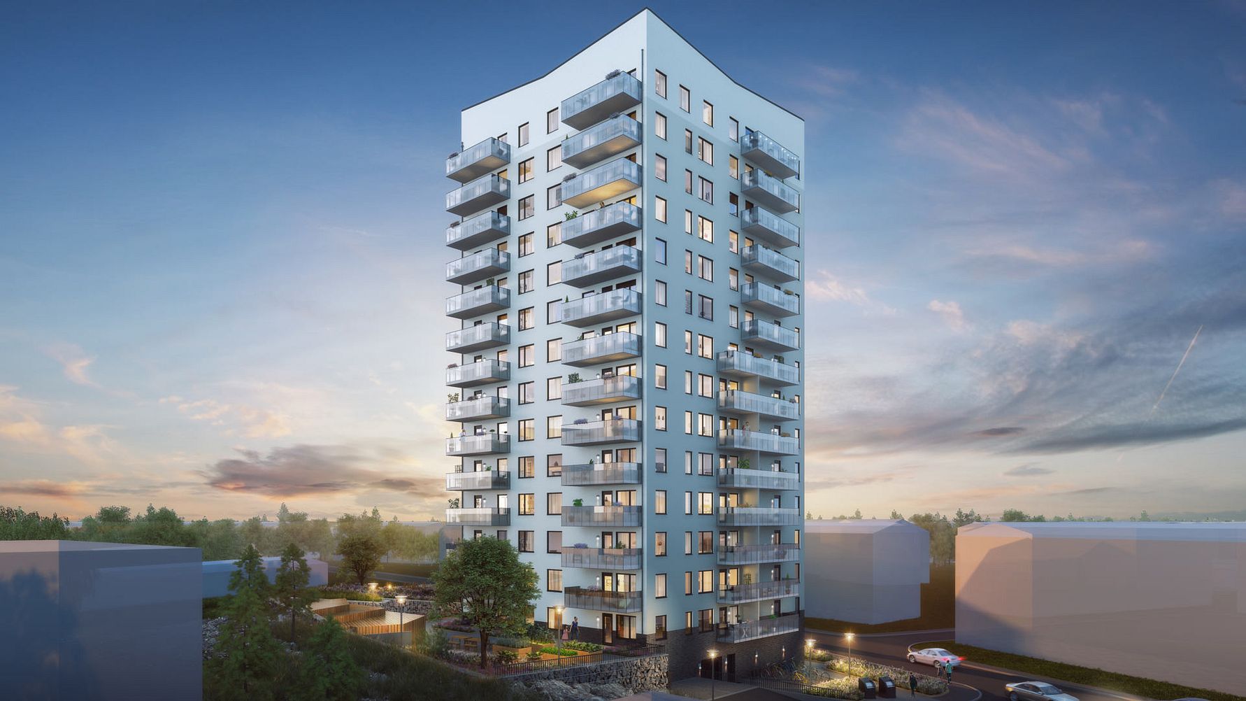 Flerfamiljshus i modern design med balkonger, omgiven av grönska och parkeringsplatser under en kvällshimmel