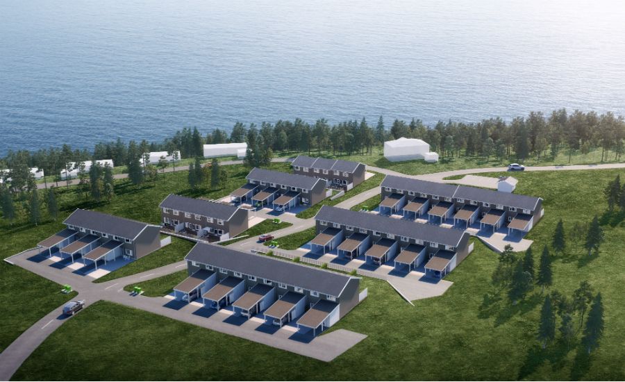 Luftvy av ett bostadsområde med radhus i en grönskande miljö nära en sjö