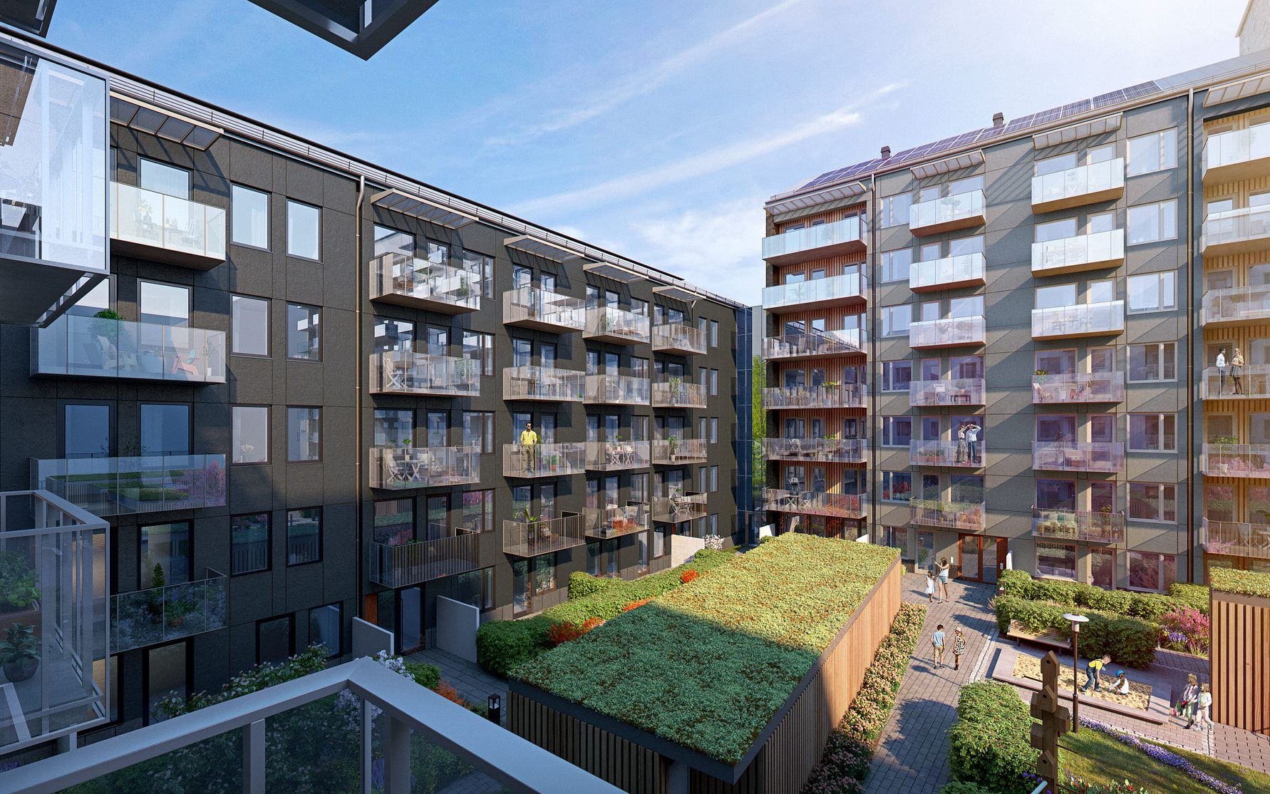 Modern bostadskomplex med flera våningar, glasbalkonger och en grön innergård under en klar himmel