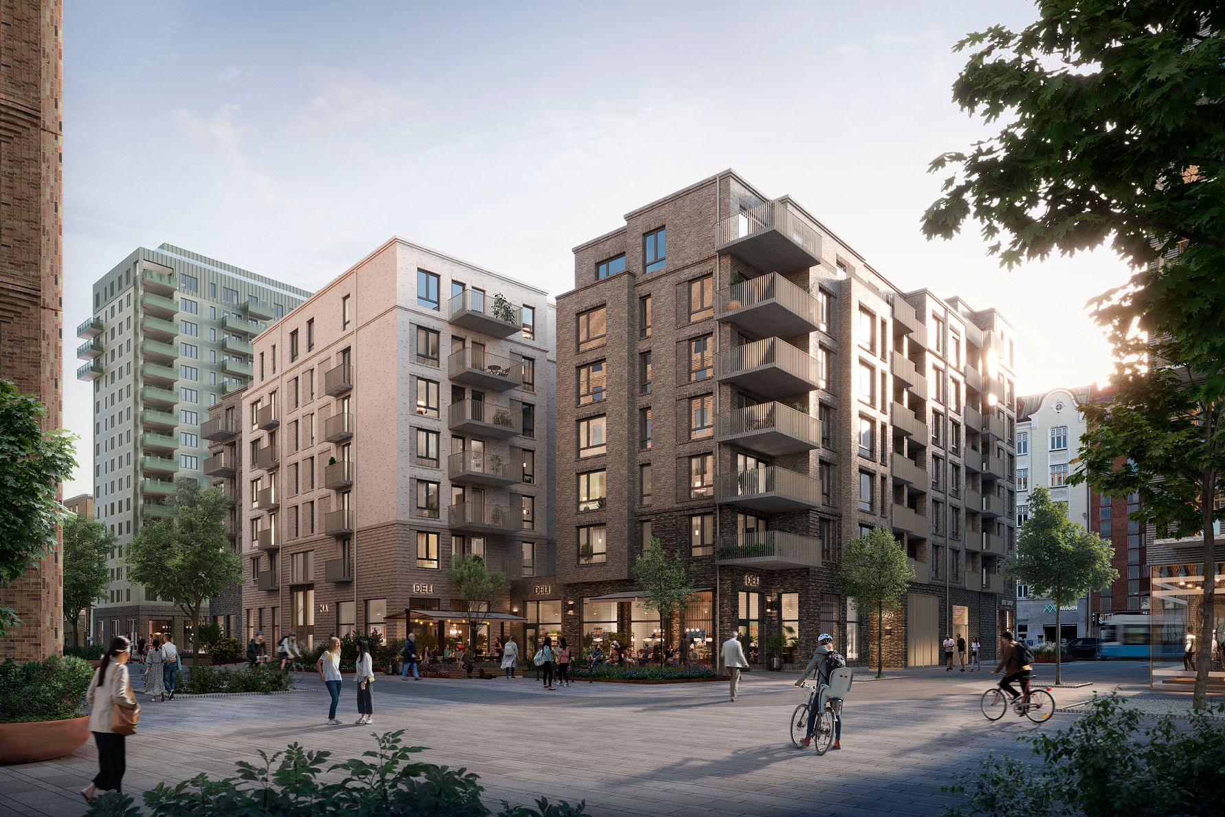 Nybyggda bostadshus med modern arkitektur, omgivna av gångvägar, cyklister, träd och människor i en urban miljö