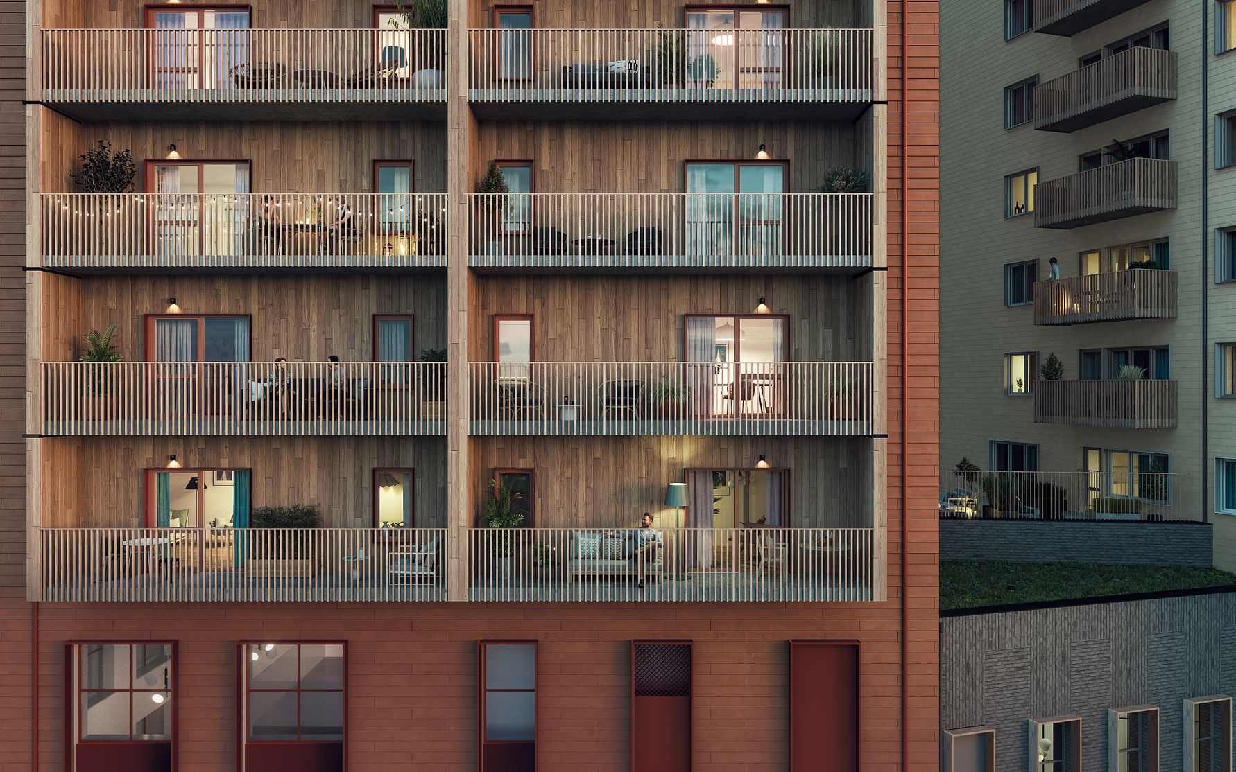 Flerbostadshus med träfasad, flera inglasade balkonger med möbler och belysning, omgivande byggnader synliga i bakgrunden