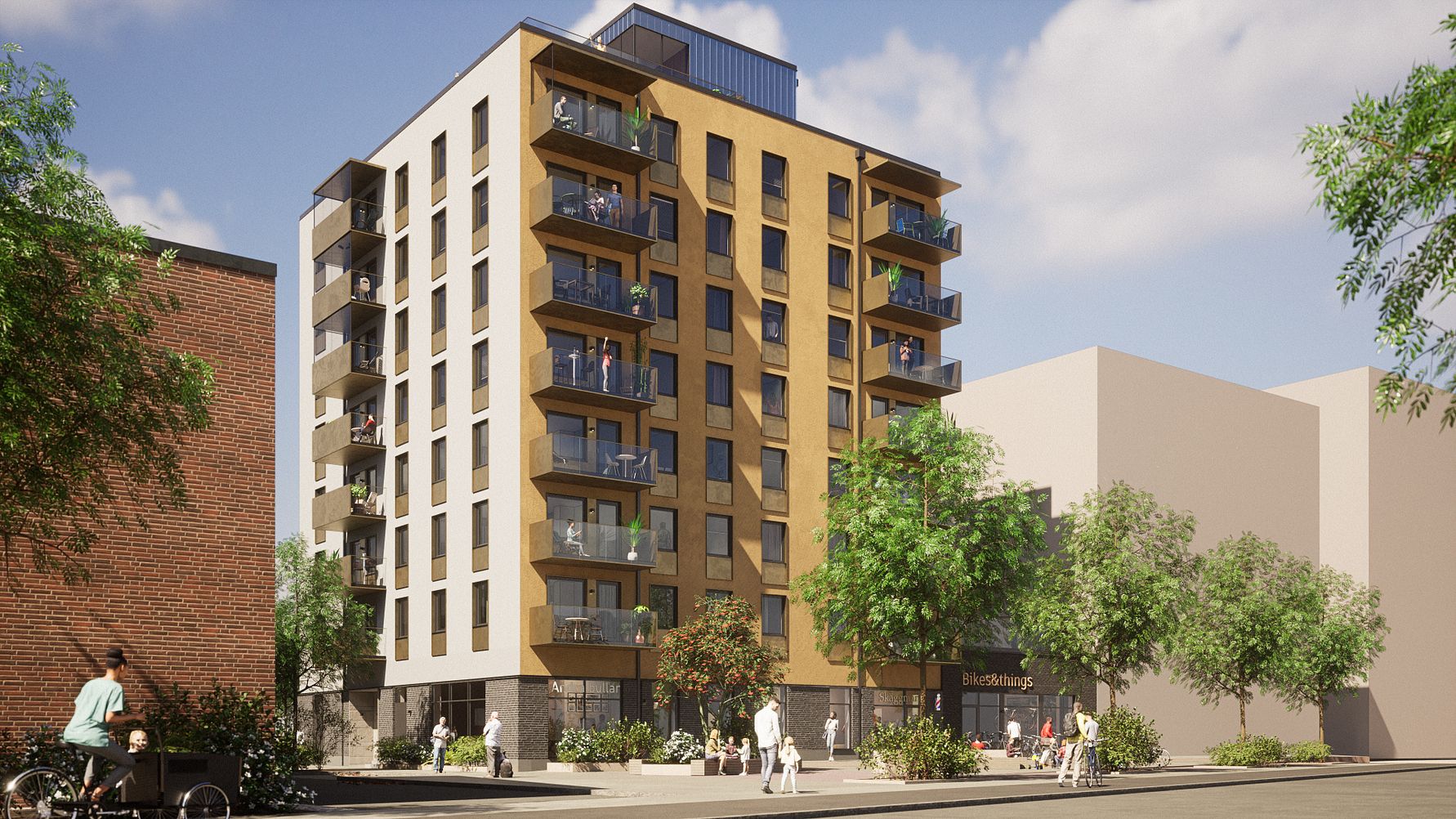 Nybyggd flerfamiljsfastighet med flera våningar, balkonger och moderna fasader, omgiven av träd och människor på trottoaren under en klar himmel