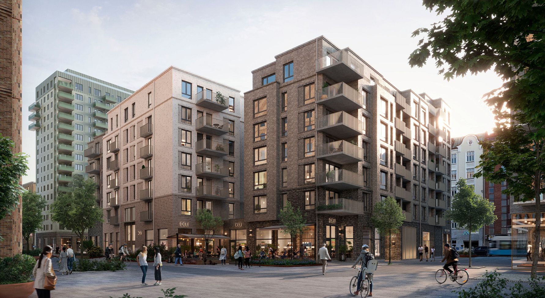 Modernt bostadshus med fasad av tegel och glas, omgiven av människor, grönska, samt en cyklist i en stadsmiljö