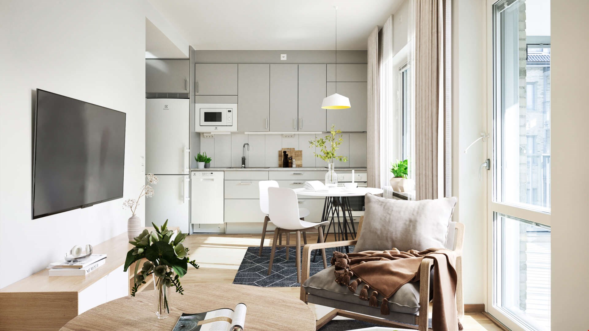 Modernt och ljust vardagsrum med öppet kök, inrett med vita köksskåp, matbord, och ljusgrå soffa nära ett stort fönster