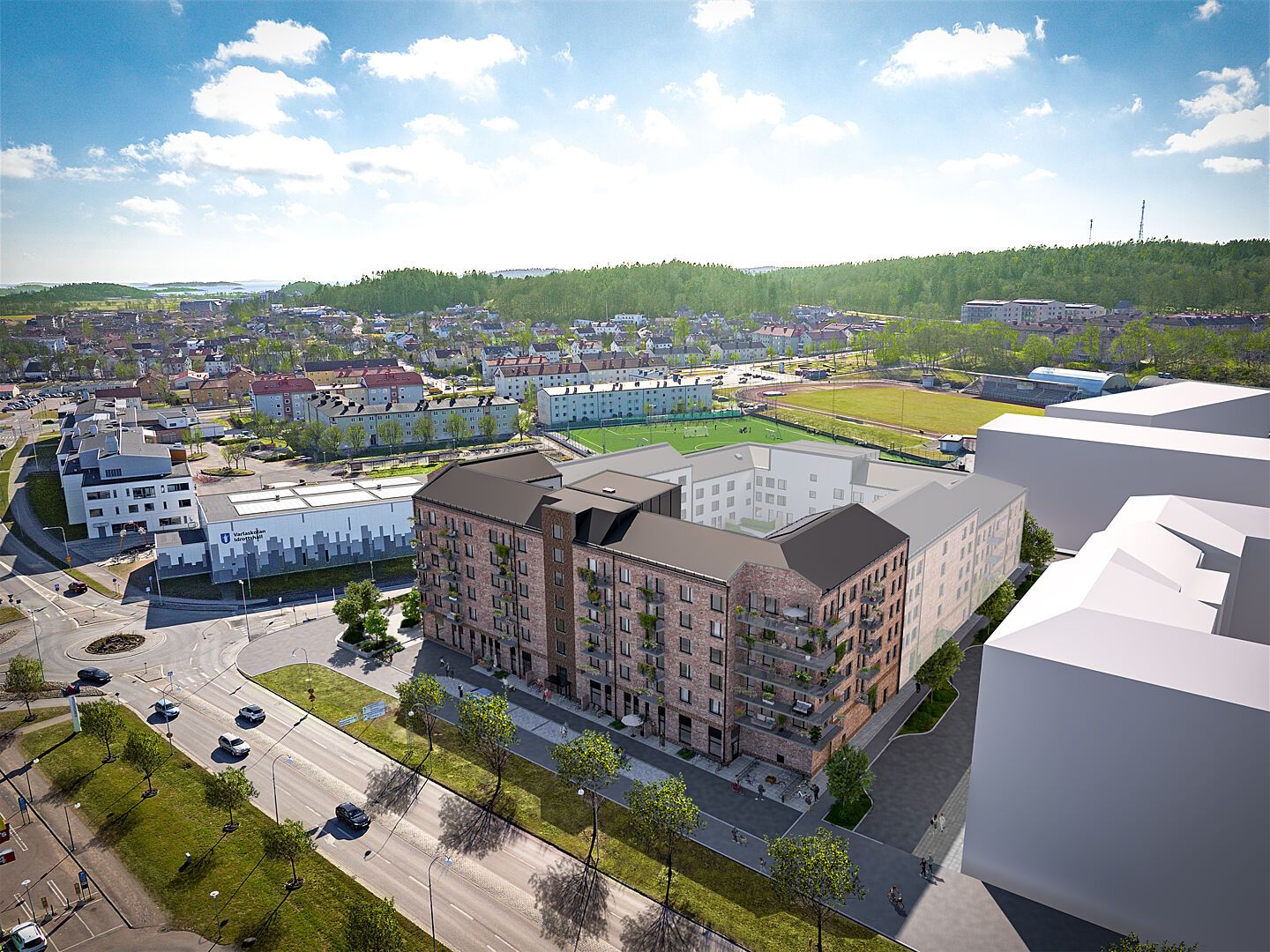 Flygvy över nybyggda bostadshus, gator och grönområden i ett bostadsområde