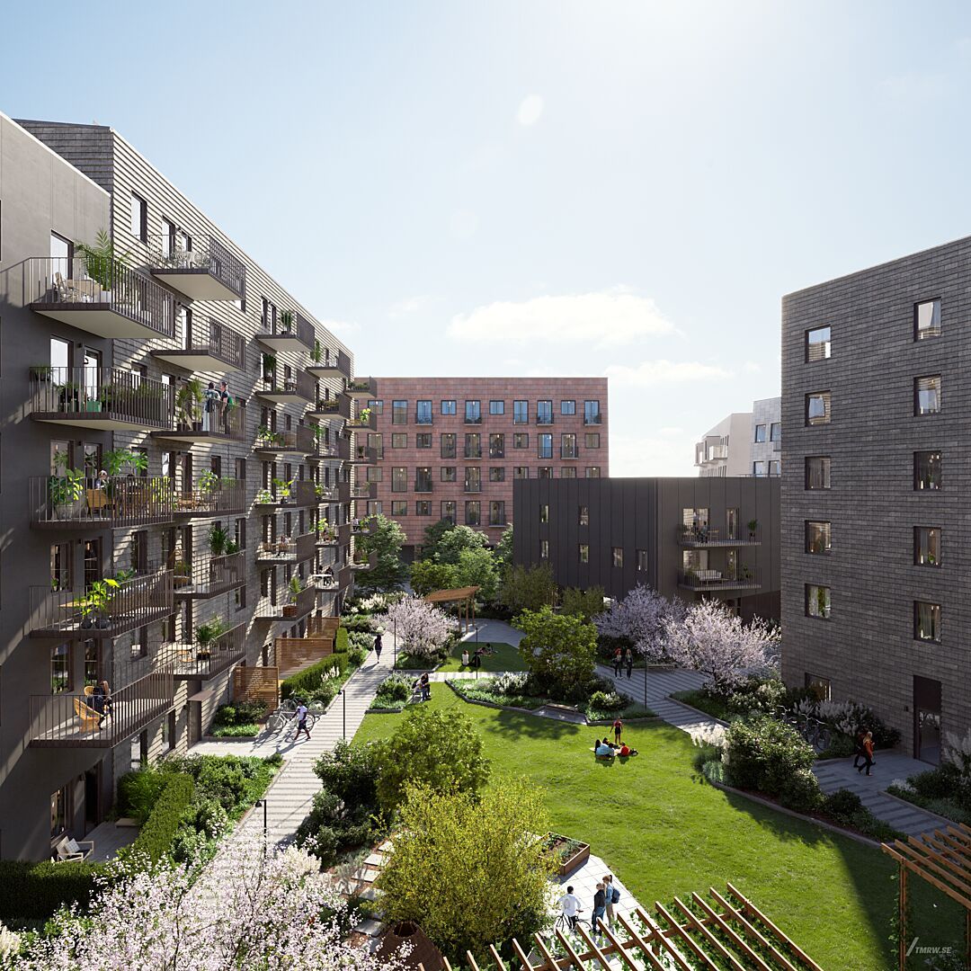 Modernt bostadsområde med flera flerfamiljshus, grönområden, blommande träd och en innergård med människor
