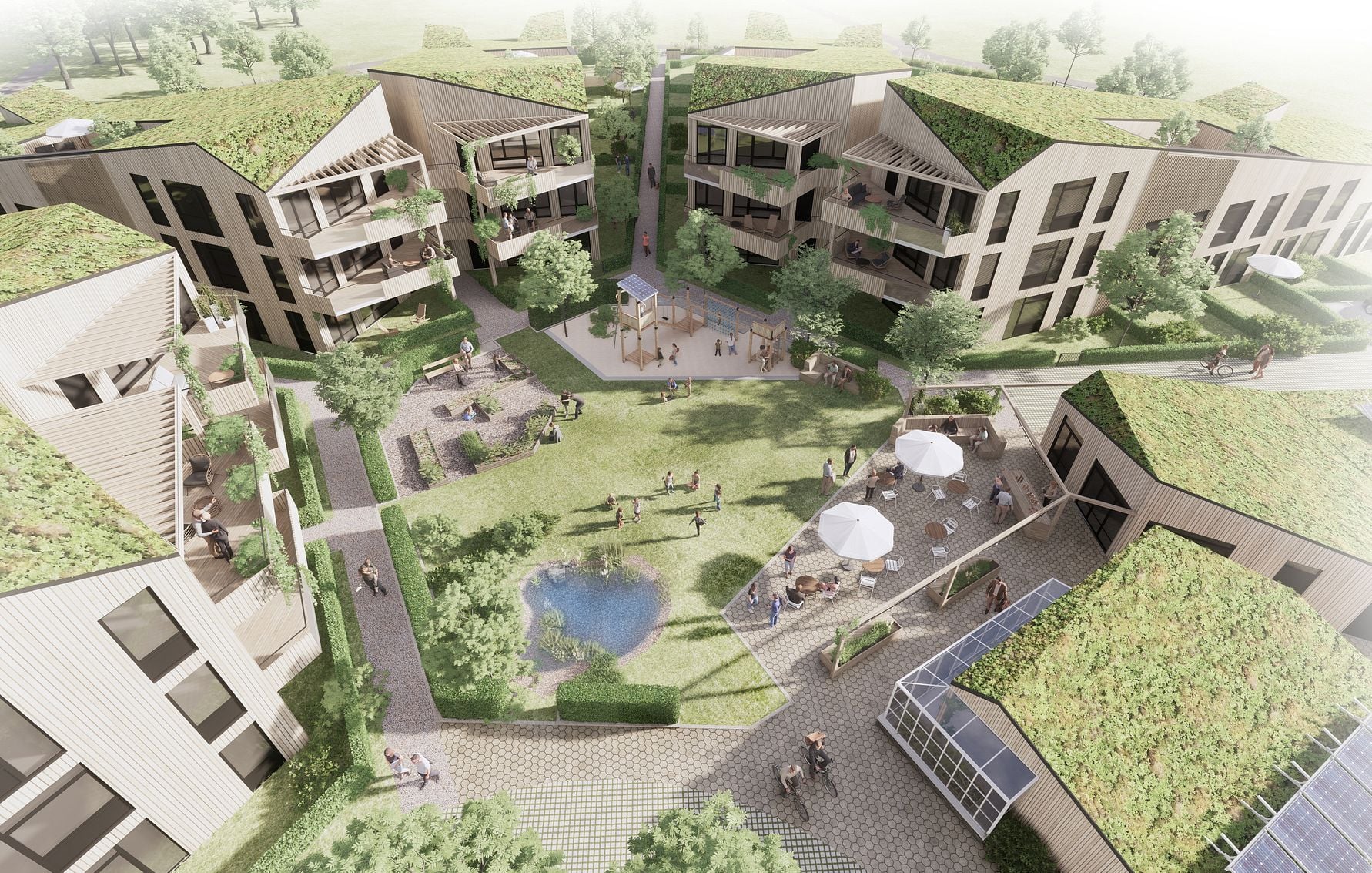 Flygvy över ett modernt bostadsområde med gröna tak, lägenhetsbyggnader, grönområden, en liten damm och människor i olika aktiviteter