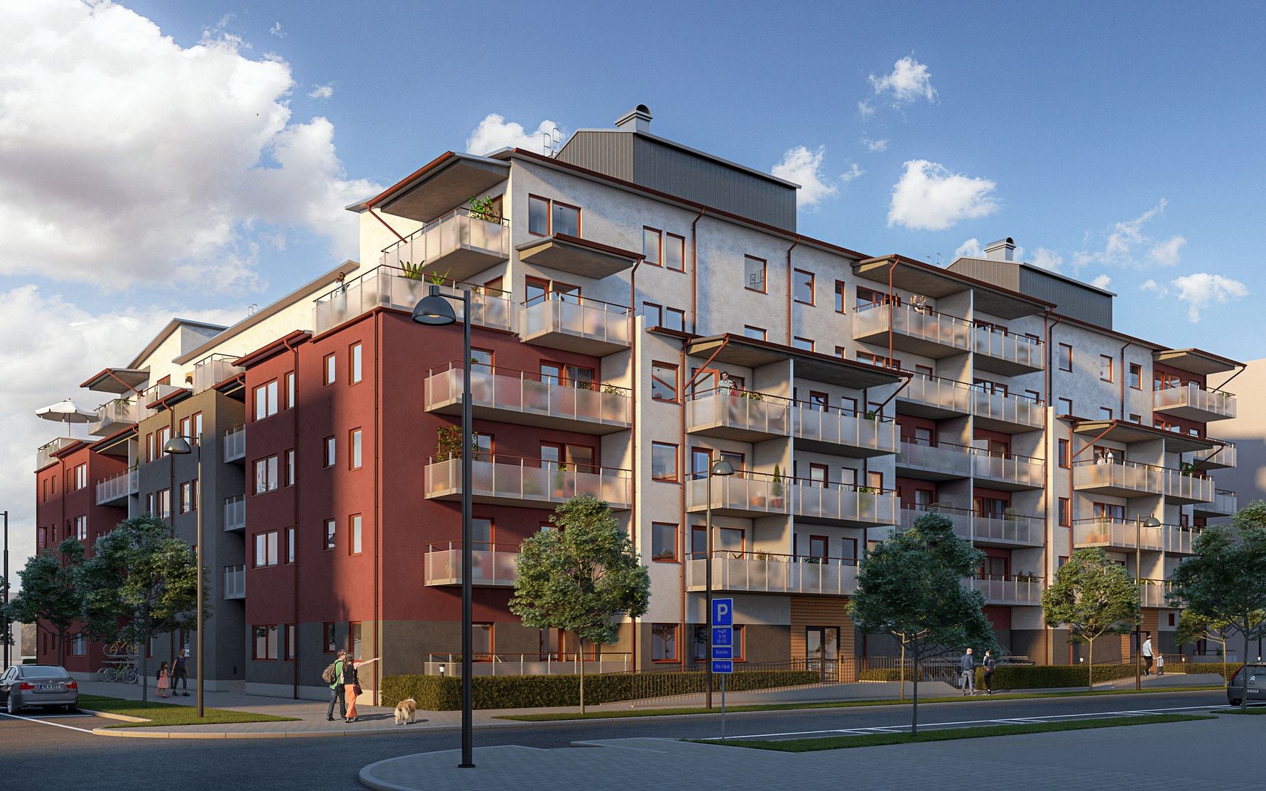 Flerfamiljshus med modern arkitektur, röda och vita fasader, flera balkonger och omgivande grönska en solig dag