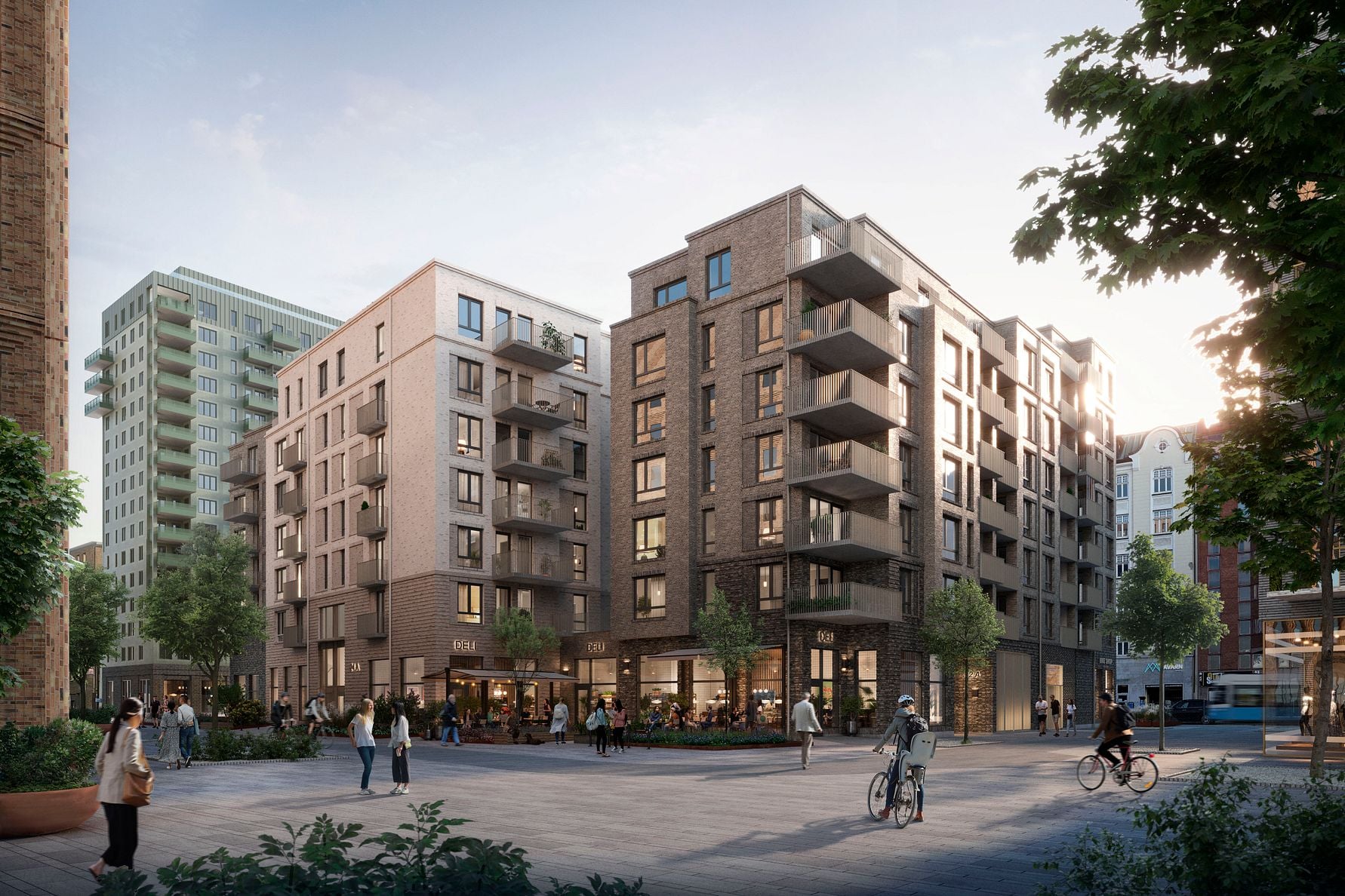 Nybyggda bostadshus med modern arkitektur, omgivna av gångvägar, cyklister, träd och människor i en urban miljö