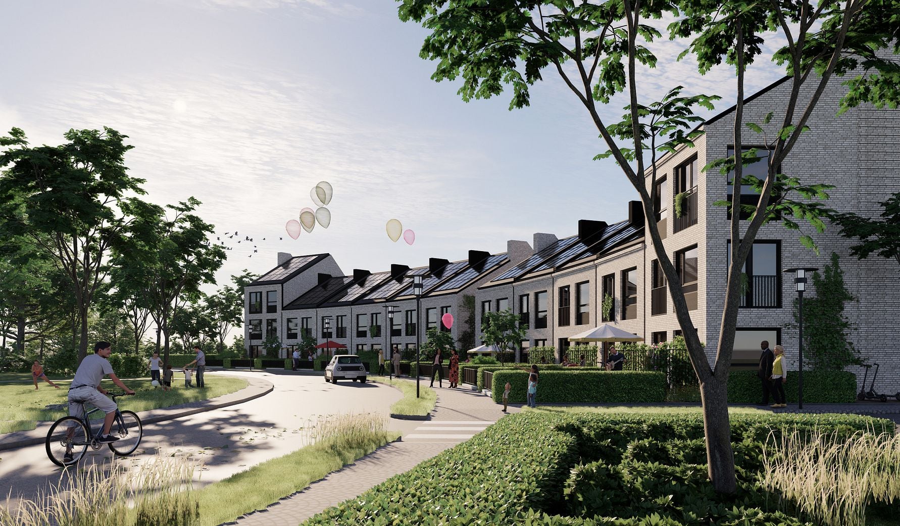 Rad av moderna bostadshus med solpaneler på taken, omgivna av grönska och träd, med människor som promenerar och cyklar i närheten. Ballonger syns svävande i luften
