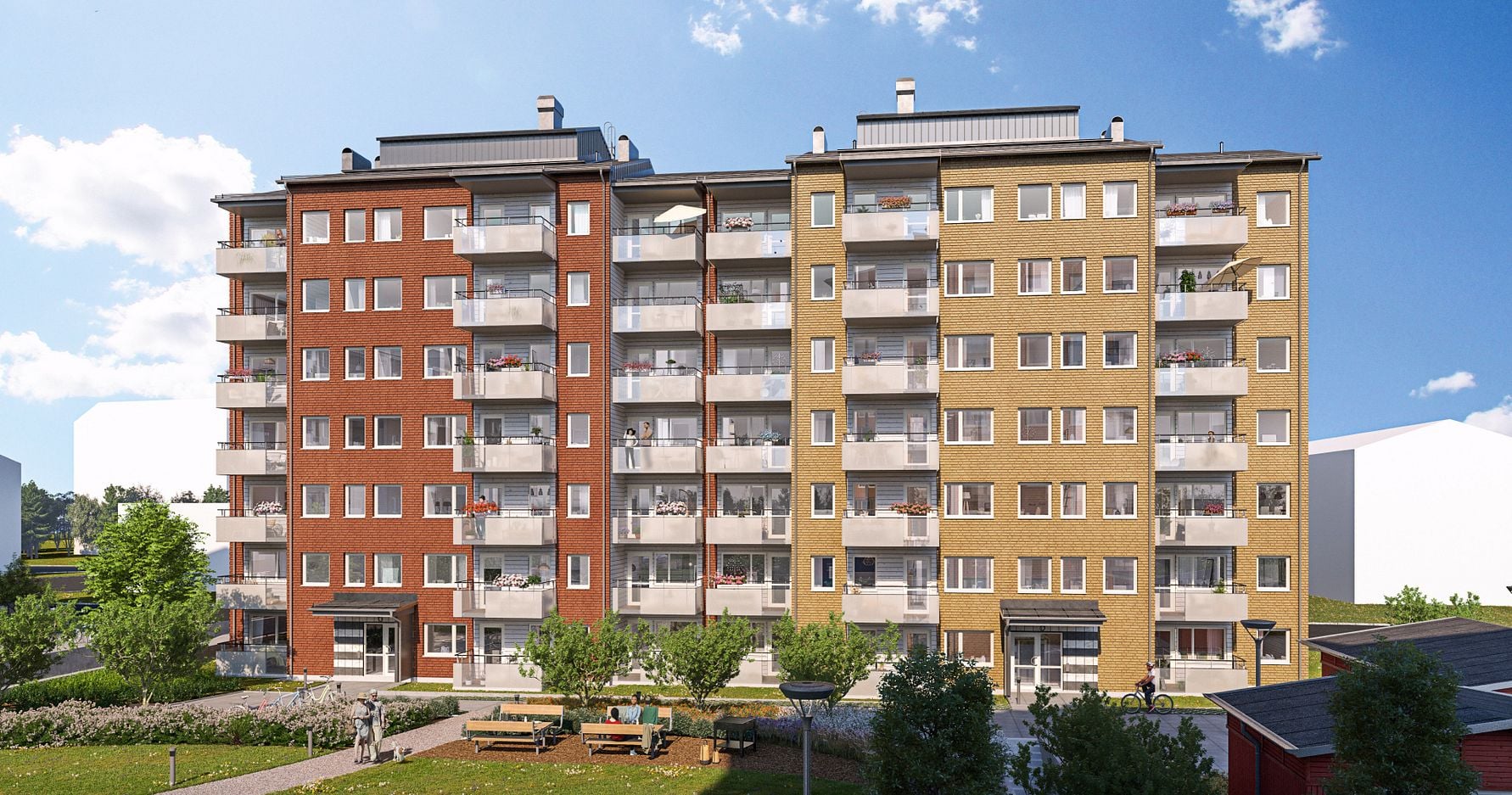 Flerfamiljshus med flera våningar, färgade fasader i rött, gult och beige, omgivna av grönska och en uteplats med bänkar