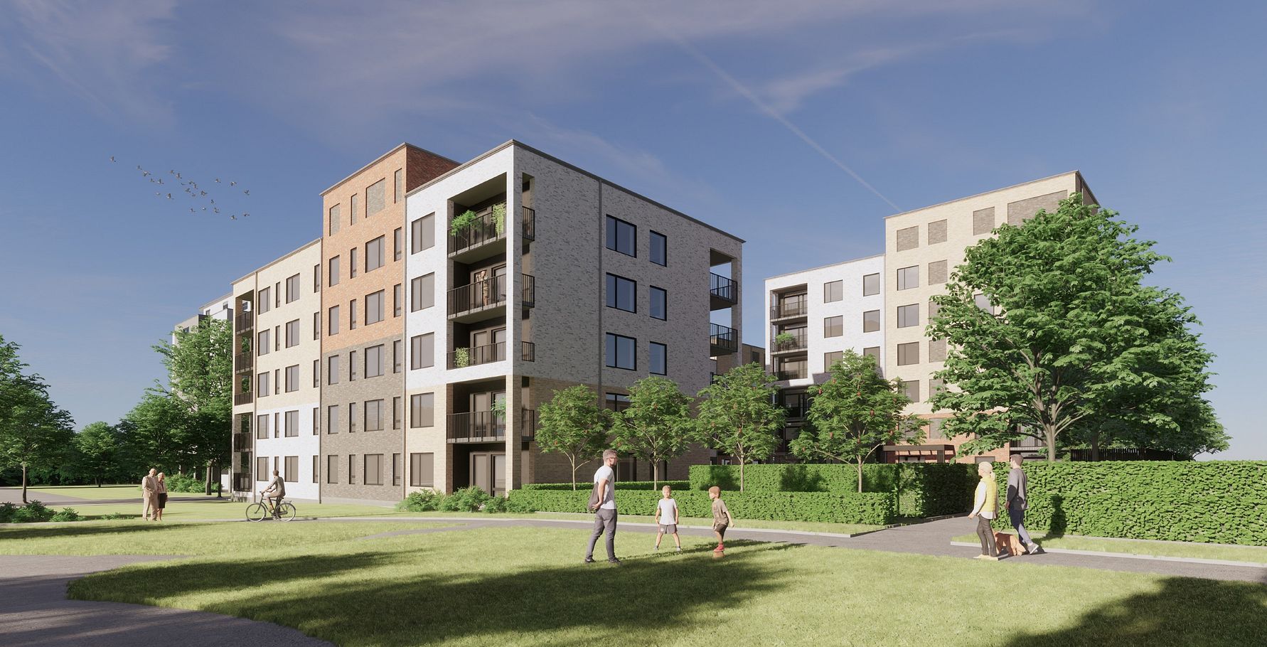 Flera moderna flerfamiljshus med balkonger omgivna av grönska och gångvägar, med människor som promenerar i parkområde