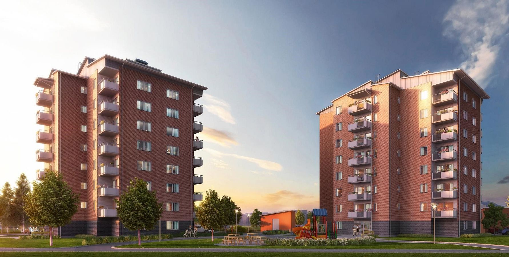 Två flerfamiljshus i röd tegel med balkonger, omgivna av grönska, en lekplats och en klar himmel vid solnedgång