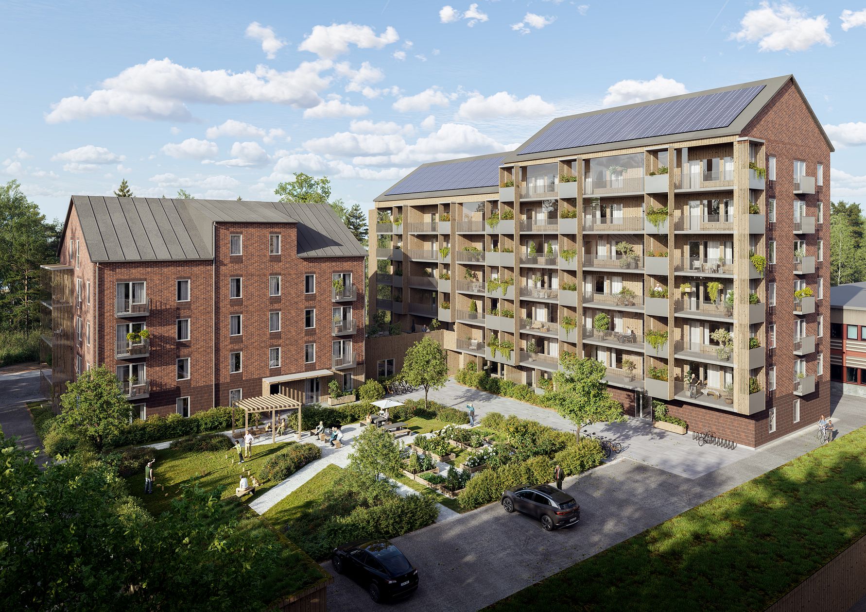 Bostadsområde med två flerfamiljshus i rött tegel, balkonger och grönskande trädgård. Solpaneler syns på taket och en park med gångvägar och bänkar ligger i förgrunden