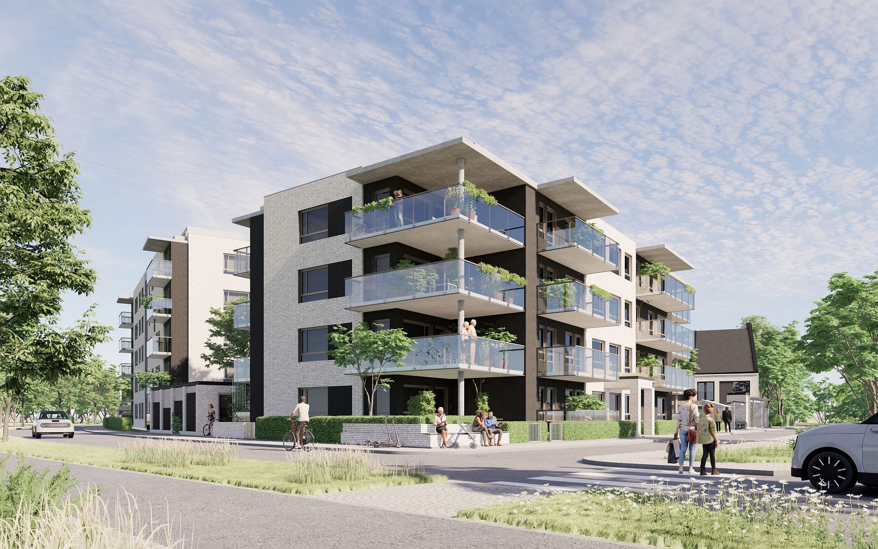 Modern lägenhetskomplex med flera våningar, stora glasbalkonger och grönskande omgivningar under en klar himmel. Människor och cyklister rör sig nära byggnaden