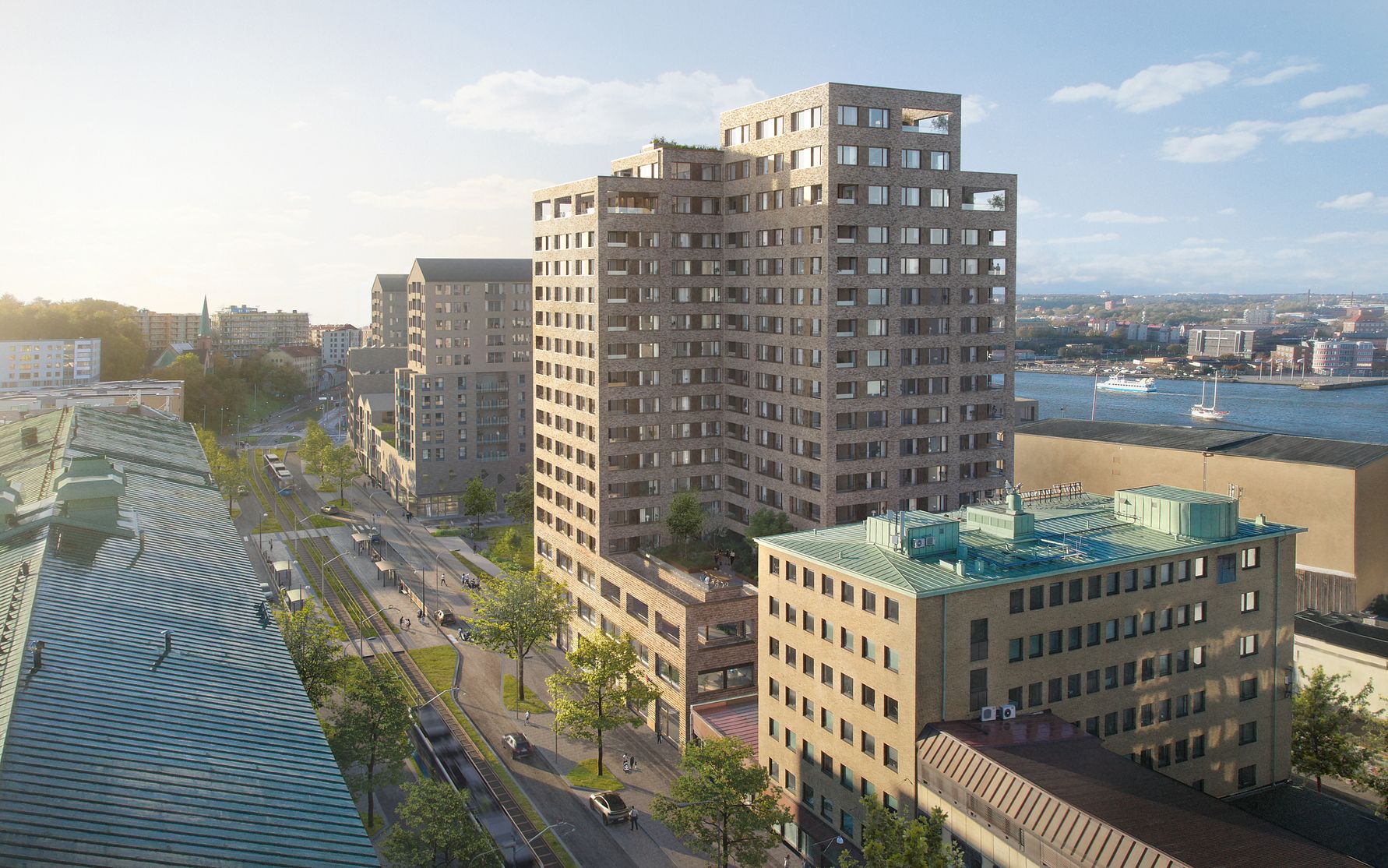 Utsikt över ett stadskvarter med moderna flerfamiljshus vid vattnet, soligt väder och båtar synliga på vattnet