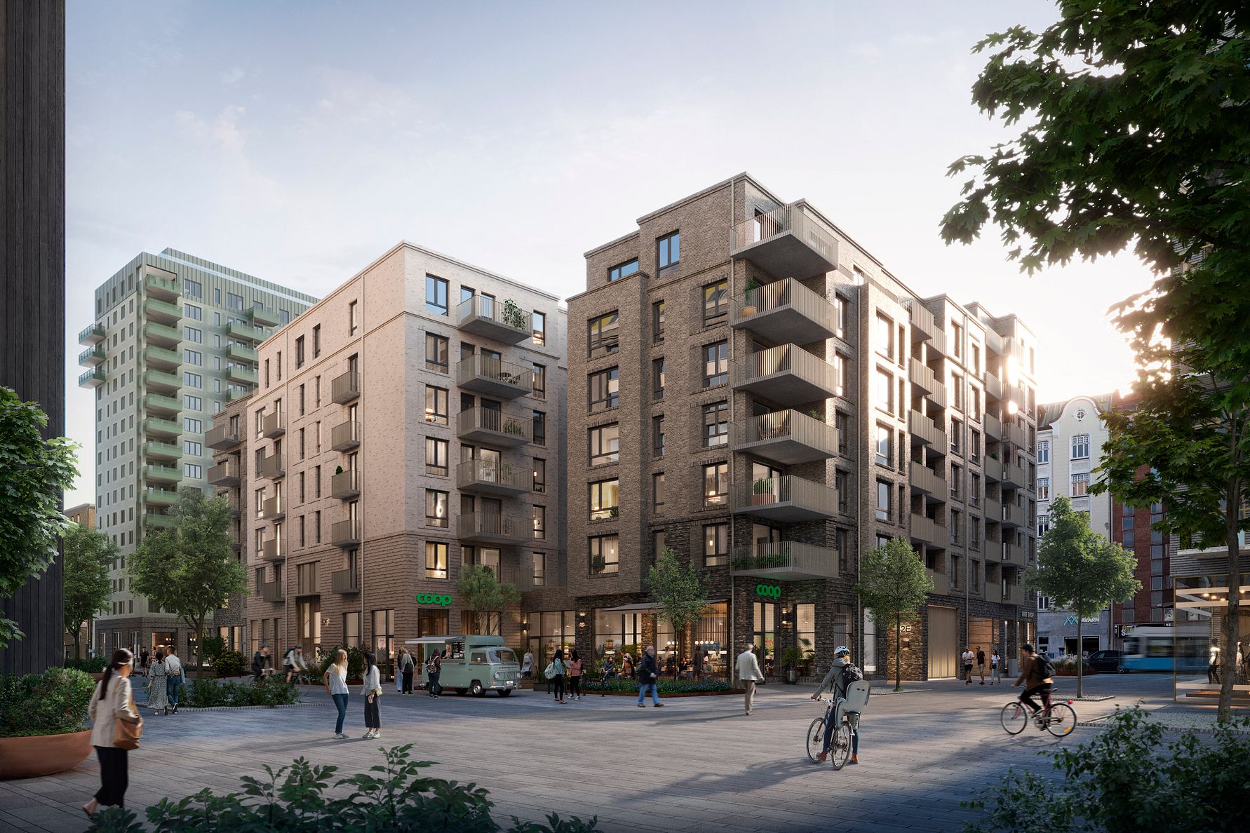 Nybyggda flerfamiljshus med modern arkitektur, omgivna av träd och en öppen stadsdel med cyklister och fotgängare i kvällsljus