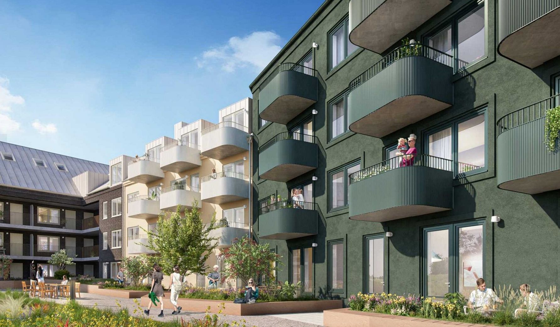 Gröna bostadsbyggnader med balkonger, omgivna av trädgårdar och människor i en utomhusmiljö under klarblå himmel