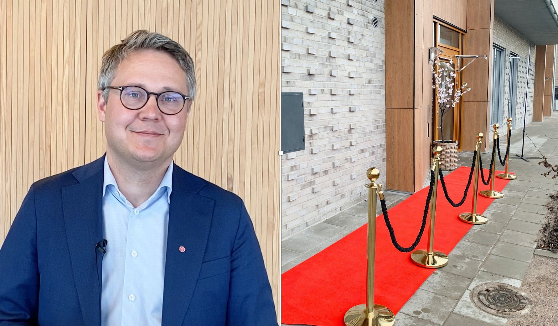 Man i blå kavaj och ljusblå skjorta står framför en trävägg; till höger en röd matta med avspärrningar utomhus bredvid en byggnad