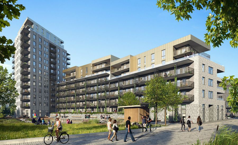 Moderna lägenhetsbyggnader med balkonger, omgivna av träd och grönska, människor som promenerar och cyklar i förgrunden