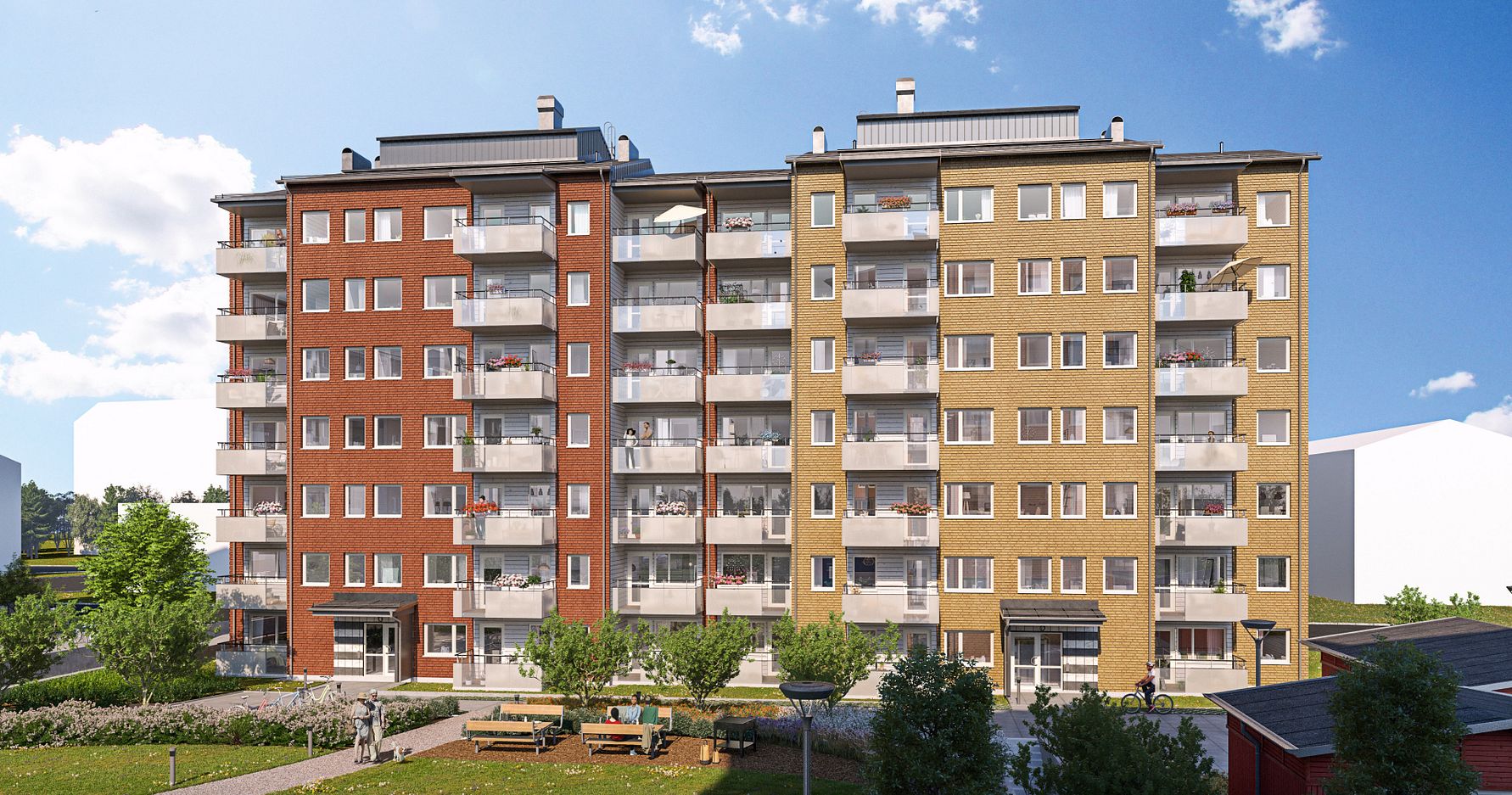 Flerfamiljshus med flera våningar, färgade fasader i rött, gult och beige, omgivna av grönska och en uteplats med bänkar