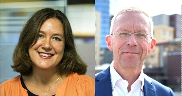 Två personer, en till vänster med brunt hår och en orange topp, och en till höger i kostym och vit skjorta, med en bakgrund av kontors- och stadsbyggnader