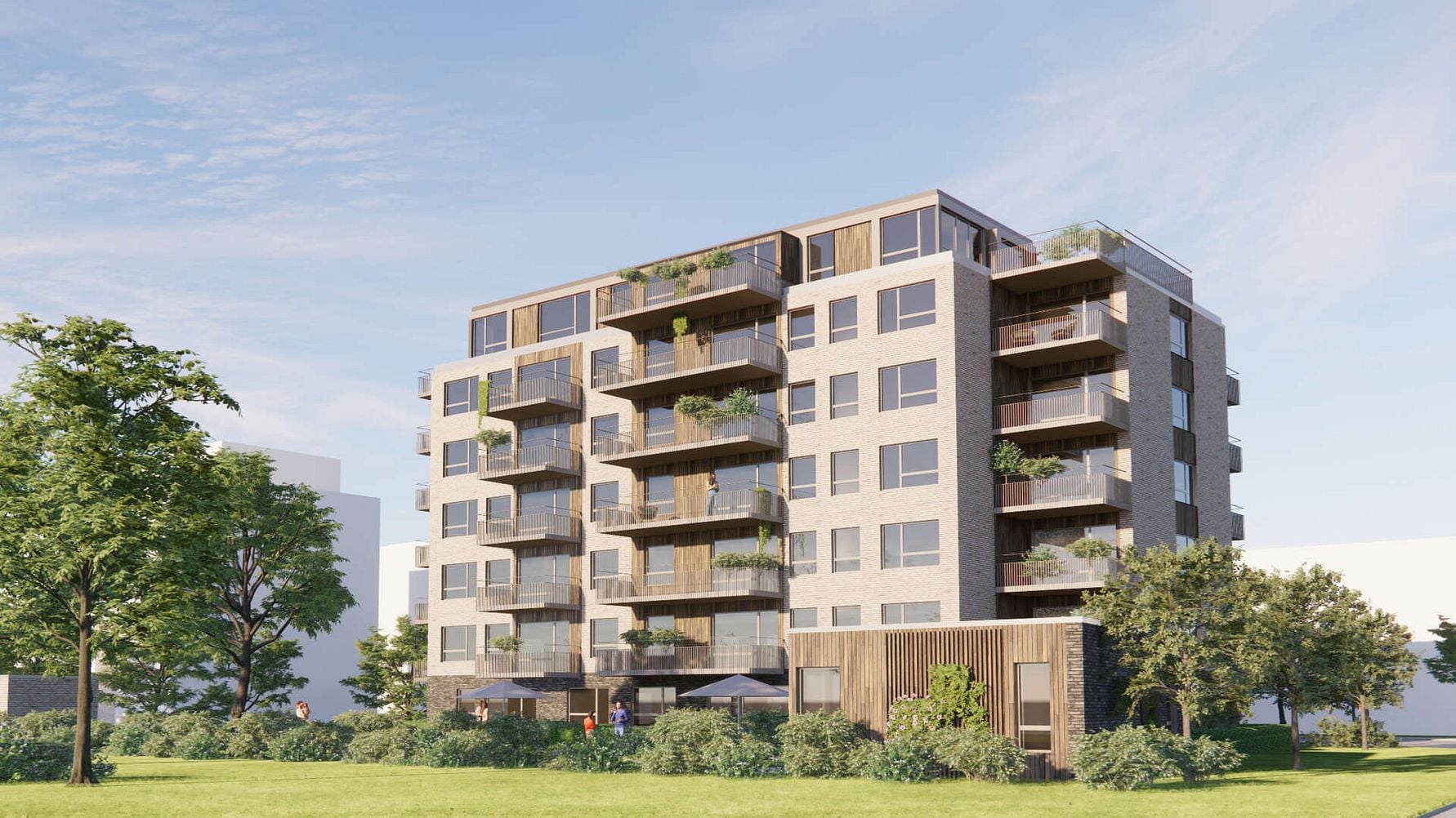 Moderna lägenhetsbyggnader med flera våningar, stora glasbalkonger och omgivna av grönområden under en klar himmel