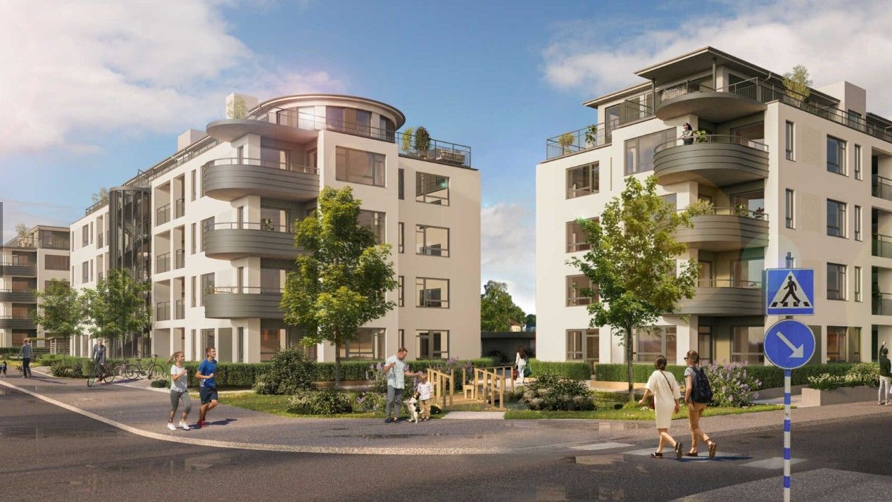 Modernt bostadsområde med flerfamiljshus, grönområden och gångvägar. Människor promenerar nära ett övergångsställe