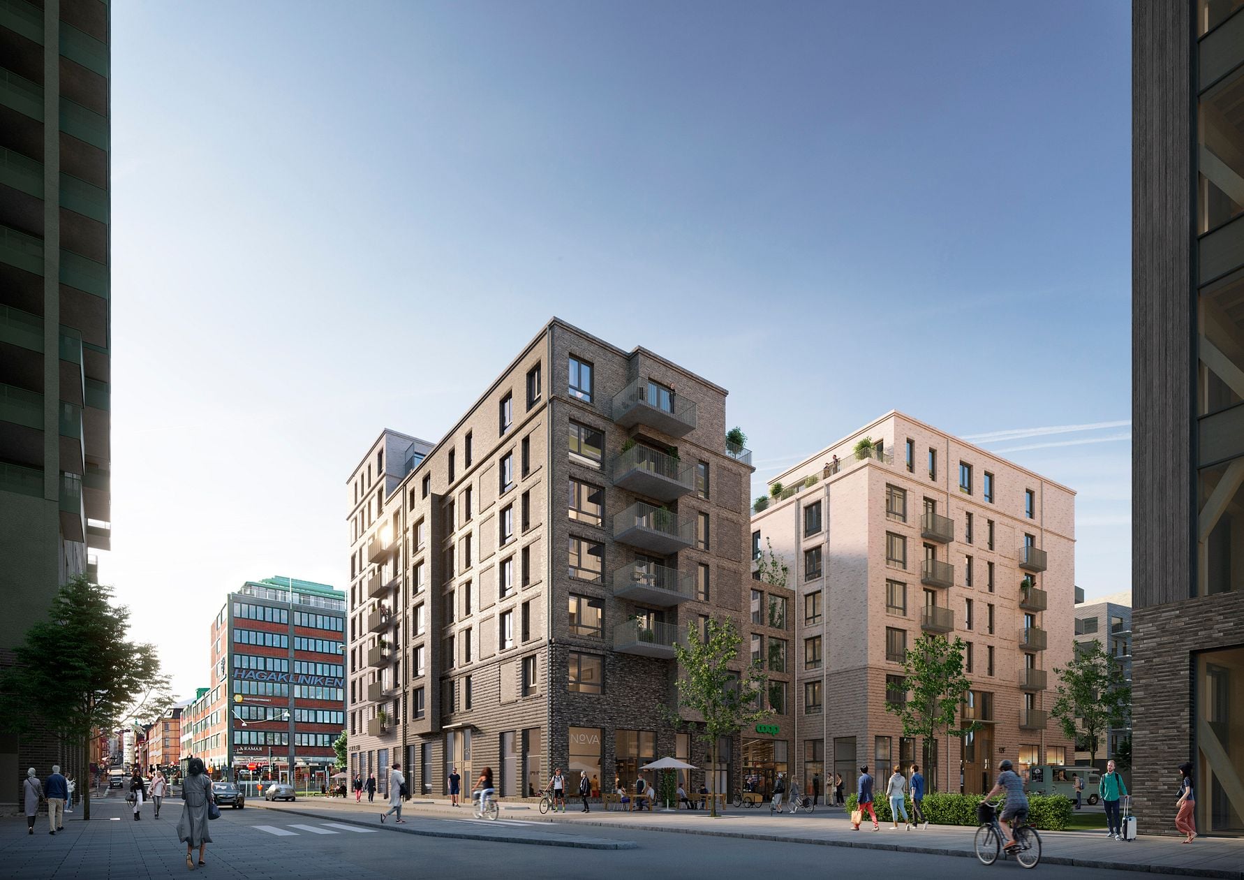 Flera moderna flerfamiljshus i stadsområde med människor som promenerar och cyklar, omgivna av träd och stadsliv