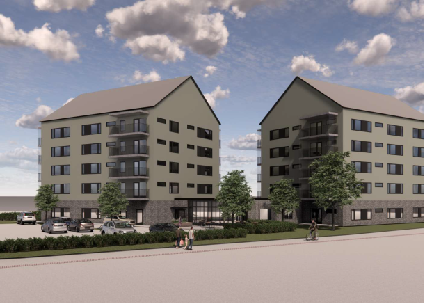 Två moderna flerfamiljshus med fem våningar, grå fasad och stora fönster, omgivna av träd och parkerade bilar under en delvis molnig himmel
