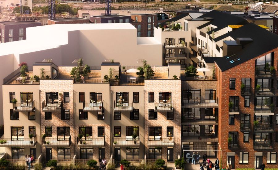 Flerbostadshus med modern arkitektur, stora fönster, terrasser och grönska, omgivna av ett stadsområde