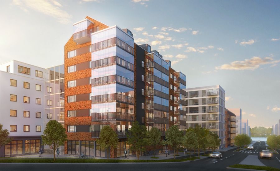 Flerbostadshus i modern arkitektur med stora glaspartier och fasader av tegel, omgivna av träd och en bred gata