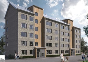 Flerfamiljshus med fasad av tegel och träpanel, omgiven av asfalt och grönska under en klar himmel